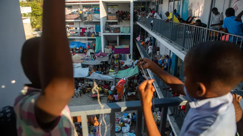 epa11221479 People gather inside a school where they are refugees in Puerto Principe, Haiti, 14 March 2024. More than a million children and adolescents are trapped by the violence of armed gangs in Haiti, living in areas controlled or under the influence of these groups, which represents a quarter of the country's child population, according to the humanitarian organization Save the Children. EPA/JOHNSON SABIN