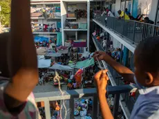 epa11221479 People gather inside a school where they are refugees in Puerto Principe, Haiti, 14 March 2024. More than a million children and adolescents are trapped by the violence of armed gangs in Haiti, living in areas controlled or under the influence of these groups, which represents a quarter of the country's child population, according to the humanitarian organization Save the Children. EPA/JOHNSON SABIN