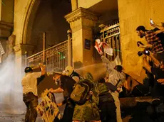 epa11313212 Georgian opposition party supporters try to break through the Georgian Parliament gate during a protest against a draft bill on 'foreign agents' in Tbilisi, Georgia, 01 May 2024. The Parliament of Georgia adopted the draft bill on 'foreign agents' in the second reading with 83 votes, 23 were against. Georgian Prime Minister Kobakhidze called on law enforcement officers to show maximum patience at protests against the 'foreign agents' law. According to Kobakhidze, the ruling Georgian Dream party will pass the bill despite the protests. EPA/DAVID MDZINARISHVILI