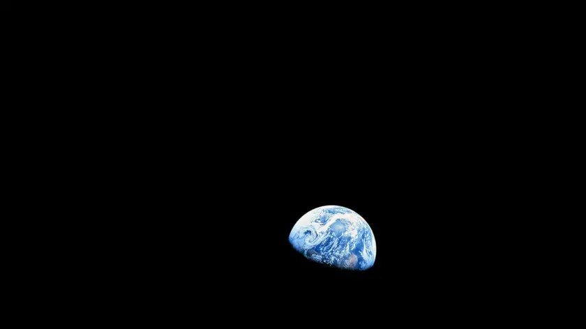 epa04000723 A handout picture released by NASA on 25 December 2013 shows a view of planet Earth seen from the Moon, at space, 24 December 1968. The Apollo Eight crew flew from Earth to the Moon and back again. Frank Borman, James Lovell, and William Anders were launched atop a Saturn V rocket on 21 December 1968, circled the Moon ten times in their command module, and returned to Earth on 27 December 1968. The Apollo Eight mission's impressive list of firsts includes: the first humans to journey to the Earth's Moon, the first to fly using the Saturn V rocket, and the first to photograph the Earth from deep space. As the Apollo Eight command module rounded the far side of the Moon on 24 December 1968, the crew could look toward the lunar horizon and see the Earth appear to rise, due to their spacecraft's orbital motion. Their famous picture of a distant blue Earth above the Moon's limb was a marvelous gift to the world. EPA/NASA HANDOUT EDITORIAL USE ONLY