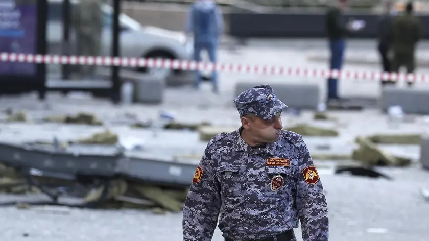 epa10776529 A Rosgvardiya officer reacts at the site of a damaged building following a reported drone attack in Moscow, Russia, 30 July 2023. The Russian Ministry of Defense on 30 July accused Ukraine of carrying out an attack with three unmanned aerial vehicles (UAV) against facilities in Moscow, adding that the attack was foiled and the three UAVs 'were suppressed by means of electronic warfare and crashed' leaving no casualties. EPA/YURI KOCHETKOV