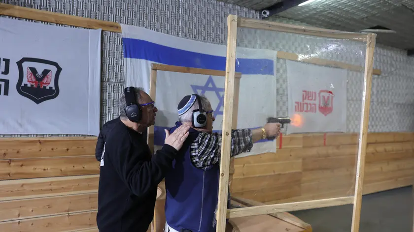 epa10444342 Israelis shoot in a shooting range in the Israeli settlement of Givat Ze'ev near Jerusalem , 02 February 2023. Currently in Israel there are approximately 155,168 firearms approved by 147,248 license holders. Right-wing National Security Minister Itamar Ben Gabir calls for a reform in the Ministry of Internal Security to ease the process of obtaining a gun license for Israeli citizens, according to a statement issued by the Israeli National Security ministry 31 January. EPA/ABIR SULTAN