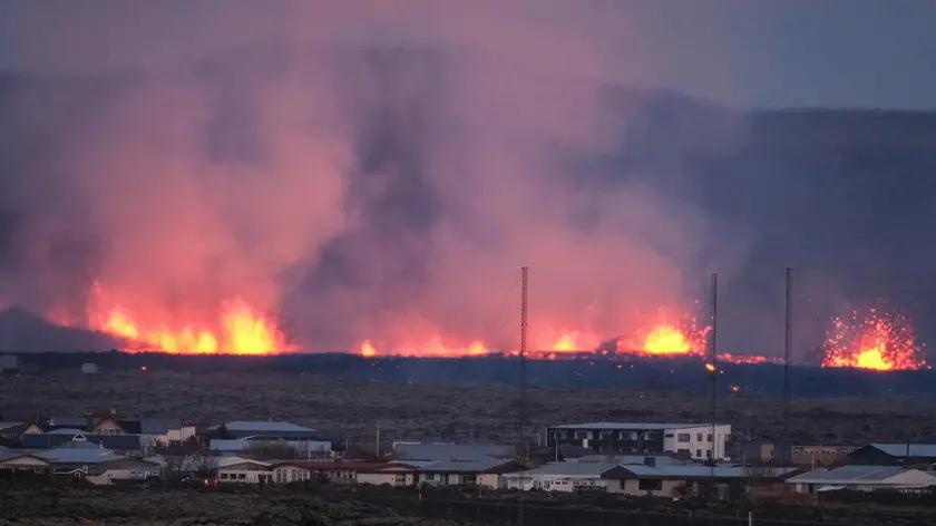epaselect epa11077207 Lava explosions and rising smoke after a volcanic eruption near the town of Grindavik, in the Reykjanes peninsula, southwestern Iceland, 14 January 2024. A volcanic eruption began north of the town of Grindavík on the Reykjanes peninsula on 14 January, prompting authorities in Iceland to evacuate the small fishing town in the early morning as a precaution. The eruption is not expected to impact additional populated areas and does not present a 'threat to life', the Government of Iceland stated, adding that there are no disruptions to flights to and from Iceland. This is the second eruption in the area since December 2023, and the fifth since 2021. EPA/ANTON BRINK