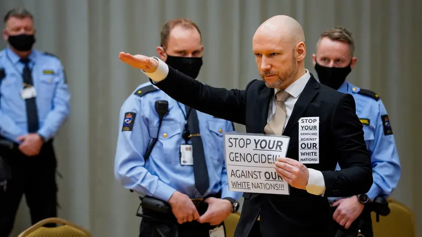 epa09692476 Mass murder Anders Behring Breivik poses with a fascist salute as he arrives for the first day of the parole hearing of Anders Breivik, in Skien, Norway, 18 January 2022. Breivik, who changed his name to Fjotolf Hansen in 2017, is to appear before court for his three-days parole hearing in Oslo on 18 January 2022. Mass murderer Anders Behring Breivik was sentenced to a maximum term of 21 years for killing 77 people in bomb and shooting attacks on 22 July 2011, and is entitled under Norwegian law to have his sentenced reviewed after ten years served. The case is being processed by Telemark District Court, but is physically taking place in a makeshift courtroom in Skien prison. EPA/Ole Berg-Rusten / POOL NORWAY OUT NORWAY OUT