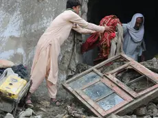 epa11280594 People salvage their belongings after heavy rains in Momand-Dara district of Nangarhar province, Afghanistan, 15 April 2024. According to the Afghanistan disaster management department, at least 33 people have been killed over three days of heavy rains and flash flooding. Authorities warned that Afghanistan's provinces will see more rain over the next few days. EPA/STRINGER