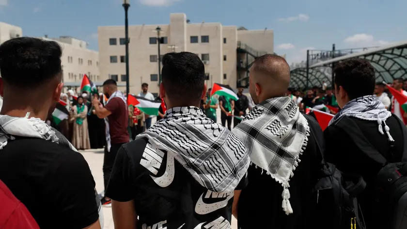 epa11545019 Palestinian students attend a protest a day after an Israeli airstrike on a school in Gaza, at Al Najah University in the West Bank city of Nablus, 11 August 2024. At least 93 people were killed in the strike on the Al-Taba'een school in Gaza’s Daraj Tuffah area, said the director of Al-Ahli Hospital in Gaza City on 10 August. More than 39,700 Palestinians and over 1,400 Israelis have been killed, according to the Palestinian Health Ministry and the Israel Defense Forces (IDF), since Hamas militants launched an attack against Israel from the Gaza Strip on 07 October 2023, and the Israeli operations in Gaza and the West Bank which followed it. EPA/ALAA BADARNEH