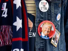 epa11097247 A supporter of former US President Donald J. Trump waits to enter a Trump campaign rally on the eve of the New Hampshire primary, in Laconia, New Hampshire, USA, 22 January 2024. The New Hampshire primary is held 23 January 2024 and is the second contest in the nominating process of the Republican presidential nomination. EPA/MICHAEL REYNOLDS