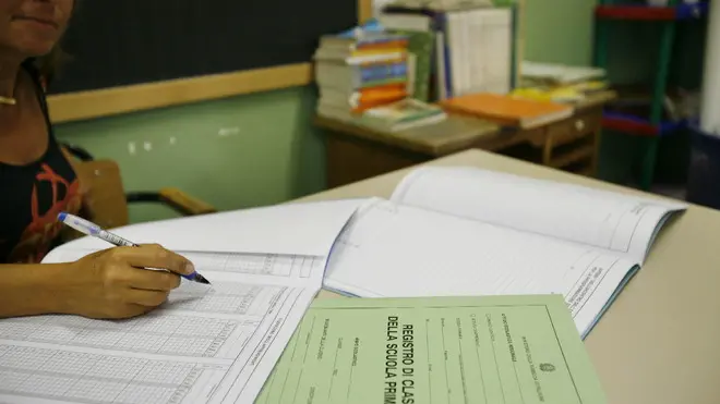 20070908-ROMA-CRO-SCUOLA: AL VIA ANNO SERIETA' PER 9 MILIONI DI STUDENTI -Un'insegnante prepara i registri per il programma didattico del nuovo anno scolastico 2007-2008. Da lunedi' inizia l'anno scolastico 2007/2008, che nelle intenzioni del ministro della Pubblica Istruzione, Giuseppe Fioroni, dovra' essere un momento di svolta per la scuola italiana, un ritorno alla serieta' e all'impegno, per studenti e docenti. La campanella suonera' (da lunedi al 18, secondo i diversi calendari regionali) per circa 9 milioni di studenti, dalla materne alle superiori.ANSA/MARTINA CRISTOFANI/DEB
