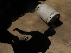 epa11183532 The shadow of a worker transferring cooking gas cylinders that are being distributed for free to the families of slain Houthi fighters, in Sanaa, Yemen, 26 February 2024. Yemen's Houthis have distributed more than 40,000 cooking gas cylinders for free to the families of slain Houthi fighters, amid rising tensions between the Houthis and the US-led coalition due to Houthis' attacks on vessels in the Red Sea and the Gulf of Aden, according to Houthi news outlets. The US-led coalition seeks to degrade the Houthis' abilities to attack commercial shipping vessels amid high tensions in the Middle East. EPA/YAHYA ARHAB