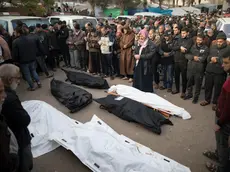 epa11038376 Relatives of Palestinians from the Nassar family, who died during Israeli air strikes in the southern Gaza Strip, pray in front of their wrapped bodies, outside Nasser Hospital in Khan Yunis, southern Gaza Strip, 20 December 2023. Israeli forces resumed military strikes on Gaza after a week-long truce expired on 01 December. More than 18,000 Palestinians and at least 1,200 Israelis have been killed, according to the Palestinian Health Ministry and the Israel Defense Forces (IDF), since Hamas militants launched an attack against Israel from the Gaza Strip on 07 October, and the Israeli operations in Gaza and the West Bank which followed it. EPA/HAITHAM IMAD