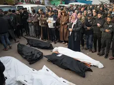 epa11038376 Relatives of Palestinians from the Nassar family, who died during Israeli air strikes in the southern Gaza Strip, pray in front of their wrapped bodies, outside Nasser Hospital in Khan Yunis, southern Gaza Strip, 20 December 2023. Israeli forces resumed military strikes on Gaza after a week-long truce expired on 01 December. More than 18,000 Palestinians and at least 1,200 Israelis have been killed, according to the Palestinian Health Ministry and the Israel Defense Forces (IDF), since Hamas militants launched an attack against Israel from the Gaza Strip on 07 October, and the Israeli operations in Gaza and the West Bank which followed it. EPA/HAITHAM IMAD
