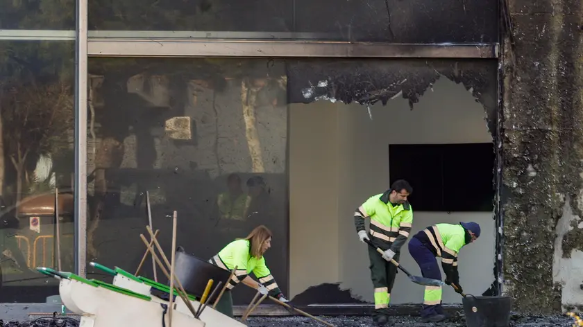 epa11186279 Municipal workers clean the area around the two buildings that were destroyed in a fire the previous week in Valencia, Spain, 28 February 2024. A fire ripped through two adjacent buildings in the evening of 22 February in Valencia, killing at least 10 people. EPA/Manuel Bruque