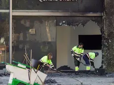 epa11186279 Municipal workers clean the area around the two buildings that were destroyed in a fire the previous week in Valencia, Spain, 28 February 2024. A fire ripped through two adjacent buildings in the evening of 22 February in Valencia, killing at least 10 people. EPA/Manuel Bruque