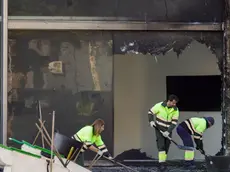 epa11186279 Municipal workers clean the area around the two buildings that were destroyed in a fire the previous week in Valencia, Spain, 28 February 2024. A fire ripped through two adjacent buildings in the evening of 22 February in Valencia, killing at least 10 people. EPA/Manuel Bruque