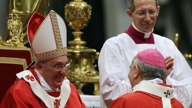 Monsignor Mario Aurelio Poli, Archbishop of Buenos Aires, Argentina, is greeted by Pope Francis after receiving the Pallium, a woolen shawl symbolizing his bond to the pope, during a mass in St. Peter's Basilica, at the Vatican, Saturday, June 29, 2013. (AP Photo/Gregorio Borgia)