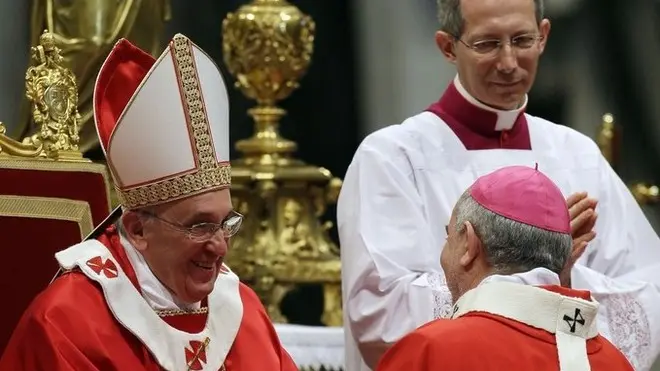 Monsignor Mario Aurelio Poli, Archbishop of Buenos Aires, Argentina, is greeted by Pope Francis after receiving the Pallium, a woolen shawl symbolizing his bond to the pope, during a mass in St. Peter's Basilica, at the Vatican, Saturday, June 29, 2013. (AP Photo/Gregorio Borgia)