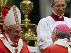 Monsignor Mario Aurelio Poli, Archbishop of Buenos Aires, Argentina, is greeted by Pope Francis after receiving the Pallium, a woolen shawl symbolizing his bond to the pope, during a mass in St. Peter's Basilica, at the Vatican, Saturday, June 29, 2013. (AP Photo/Gregorio Borgia)