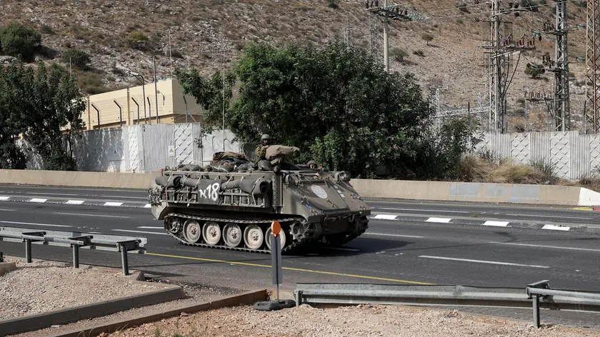 epa10950153 Israeli soldiers aboard an armored personnel carrier (APC) on patrol at a main road near the town of Kiryat Shmona, near the Israel-Lebanon border, Israel, 31 October 2023. Tensions remain high at the border between Israel and Lebanon after the Israeli-Palestinian conflict escalated following an unprecedented attack carried out by Hamas militants from Gaza into Israel on 07 October 2023. EPA/ATEF SAFADI