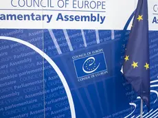 epa11434595 The logo of the Council of Europe pictured next to a European flag, in the Palace of Europe, during the third part of the 2024 Ordinary Session of the Parliamentary Assembly of the Council of Europe (PACE), in Strasbourg, France, 24 June 2024. The Parliamentary Assembly of the Council of Europe elects the new secretary general of the council of Europe to succeed Marija Pejcinovic Buric. EPA/ANTHONY ANEX