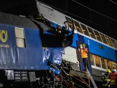 epaselect epa08546514 Firefighters work in the aftermath of a train crash near the city of Cesky Brod, Czech Republic, 15 July 2020. According to media reports, at least one person died and 35 people were injured after a cargo and a passenger train collided between Uvaly and Cesky Brod. EPA/MARTIN DIVISEK