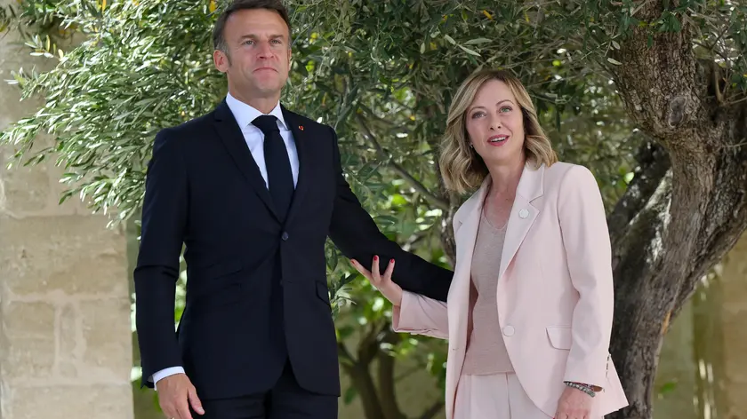 epa11407583 Italy's Prime Minister Giorgia Meloni (R) greets French President Emmanuel Macron (L) during a welcome ceremony for the G7 summit in Borgo Egnazia, southern Italy, 13 June 2024. The 50th G7 summit will bring together the Group of Seven member states leaders in Borgo Egnazia resort in southern Italy from 13 to 15 June 2024. EPA/ETTORE FERRARI