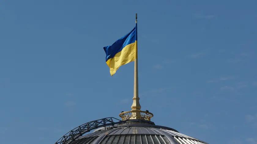 epa11561539 The Ukrainian national flag waves on top of the Verkhovna Rada (Parliament) building during an official visit by India's Prime Minister Modi, in Kyiv, Ukraine, 23 August 2024. The Indian prime minister arrived in Ukraine to meet with top Ukrainian officials amid the ongoing Russian invasion. EPA/SERGEY DOLZHENKO