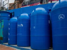 epa09520338 Rainwater tanks and filters at the entrance of a school, on 10 October 2021, in Caracas, Venezuela (issued 12 October 2021). The children of two schools in Petare, the largest neighborhood in Venezuela, attended classes with a bucket of water due to the constant failures of the service in the sector, but with the capture and treatment of water resources from the rains, promoted by the Lata de Agua social project, the liquid comes out of the taps again. The initiative is developed by the architects Ana Babic and Laurencio Sanchez from their company Arqbiental, in alliance with the Rayo de Luz foundation, with which they were able to install their pilot test in these two schools and an outpatient clinic. EPA/Miguel Gutierrez
