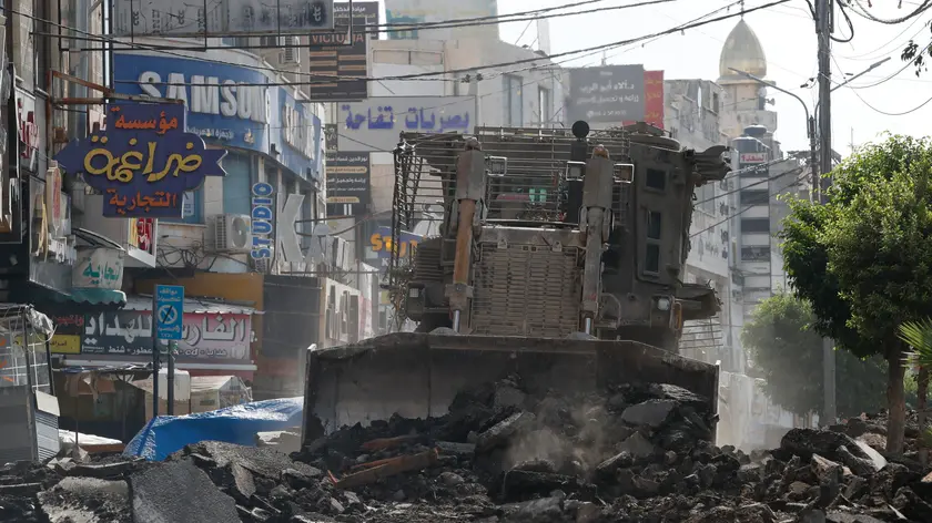epa11576922 Israeli bulldozers destroy streets and shops on the fifth day of an Israeli military operation in the West Bank city of Jenin, 01 September 2024. According to the Palestinian Health Ministry, at least 24 Palestinians have been killed since Israeli military operations started on 28 August 2024 in the West Bank cities of Tulkarem, Jenin and Tubas. The Israeli army said that it's conducting a large-scale counter-terrorism operation in several areas. More than 40,000 Palestinians and over 1,400 Israelis have been killed, according to the Palestinian Health Ministry and the Israel Defense Forces (IDF), since Hamas militants launched an attack against Israel from the Gaza Strip on 07 October 2023, and the Israeli operations in Gaza and the West Bank which followed it. EPA/ALAA BADARNEH