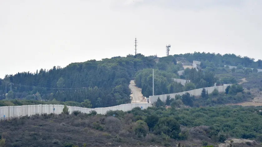 epa10913221 A view of the wall at the Israeli-Lebanon border, seen from Dhayra village, southern Lebanon, 11 October 2023. Hezbollah said on 11 October it fired missiles on Israel, two days after three of its members were killed in border towns. The Israel Defence Forces (IDF) said an anti-tank missile was launched from Lebanon toward a military post adjacent to the community of Arab Al-Aramshe on the BlueLine, and it responded by shelling Southern Lebanese towns. EPA/WAEL HAMZEH
