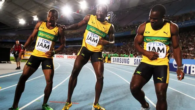 epa02898213 The Jamaican 4x100m relay runners Nesta Carter (R), Usain Bolt (C) and Yohan Blake celebrate after setting a new World Record in the men's 4x100m final at the 13th IAAF World Championships in Daegu, Republic of Korea, 04 September 2011. EPA/DIEGO AZUBEL