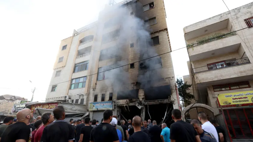 epa10948652 Palestinians inspect the damage at a bullding in the West Bank city of Jenin, 30 October 2023. According to the Palestinian Health Ministry, at least four Palestinians have been killed and five others injured during Israeli raids in Jenin. EPA/ALAA BADARNEH