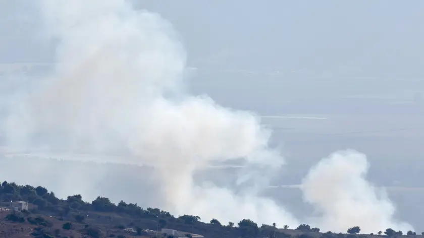 epa11598680 Smoke rises from Kfar Szold in the Upper Galilee, northern Israel, 11 September 2024, as a result of a projectile fired from Lebanon. The Israeli military stated that approximately 30 projectiles were identified crossing from Lebanese territory into Israel and fell in an open area. EPA/ATEF SAFADI