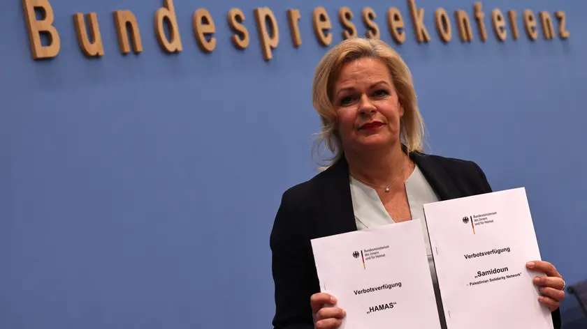 epa10953990 German Interior Minister Nancy Faeser poses with banning orders for activity of Hamas and Samidoun organizations during a press conference at the House of the Federal Press Conference in Berlin, Germany, 02 November 2023. German Interior Minister Nancy Faeser and President of the Federal Office for Information Security (BSI) Claudia Plattner presented the BSI Situation Report 2023. EPA/CLEMENS BILAN