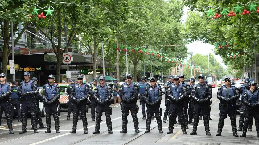 epa06351559 Victoria Police officers stand guard during a protest against Manus Island in Melbourne, Australia, 26 November 2017. The protesters demanded that asylum seekers who are refusing to leave closed Australian-run detention centre in Papua New Guinea (PNG) should be evaccuated to Australia. A group fo asylum seekers was moved to new housings after the offshore detenetion center shut on 31 October. EPA/MAL FAIRCLOUGH AUSTRALIA AND NEW ZEALAND OUT