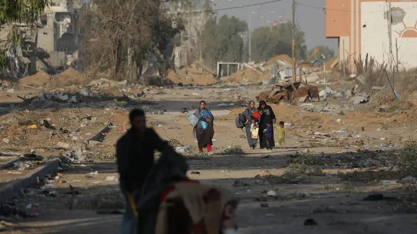 epa10993182 Palestinians walk after crossing from the northern Gaza Strip to the southern Gaza Strip along Salah Al Din road in the central Gaza Strip, 24 November 2023. After Israel and Hamas agreed to a four-day ceasefire, mediated by Qatar, the US, and Egypt, that came into effect at 05:00 AM GMT on 24 November, some Palestinians who were still in central Gaza moved towards the south while others already displaced in the south went back to the northern part to check on relatives they had left behind and on their homes to collect salvageable belongings. As part of the ceasefire, the agreement included that 50 Israeli hostages, women and children, are to be released by Hamas. 150 Palestinian women and children that were detained in Israeli prisons are to be released in exchange. More than 14,000 Palestinians and at least 1,200 Israelis have been killed, according to the Gaza Government media office and the Israel Defense Forces (IDF), since Hamas militants launched an attack against Israel from the Gaza Strip on 07 October, and the Israeli operations in Gaza and the West Bank which followed it. EPA/MOHAMMED SABER