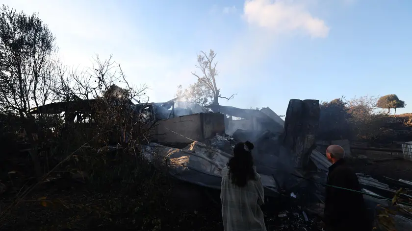epa11617812 A firefighter douses a fire coming from projectiles fired from south Lebanon near Safed, northern Israel, 21 September 2024. The Israeli Defense Forces (IDF) said that "approximately 90 projectile launches were identified crossing from Lebanon into Israeli territory." Furthermore, the Air Force "struck thousands of launcher barrels that were ready for immediate use to fire toward Israeli territory." EPA/ATEF SAFADI
