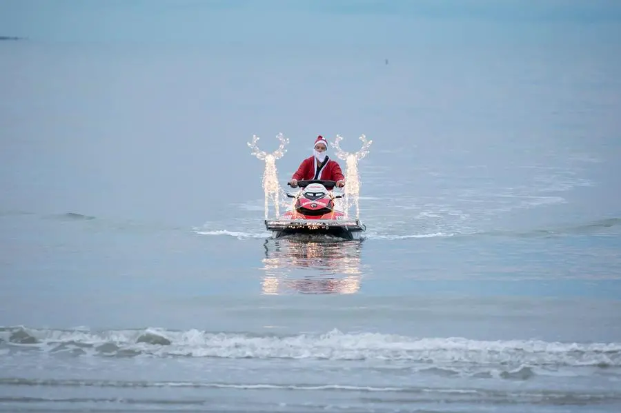 L'arrivo di Babbo Natale sulla spiaggia con la moto d'acqua e le renne Foto Bonaventura