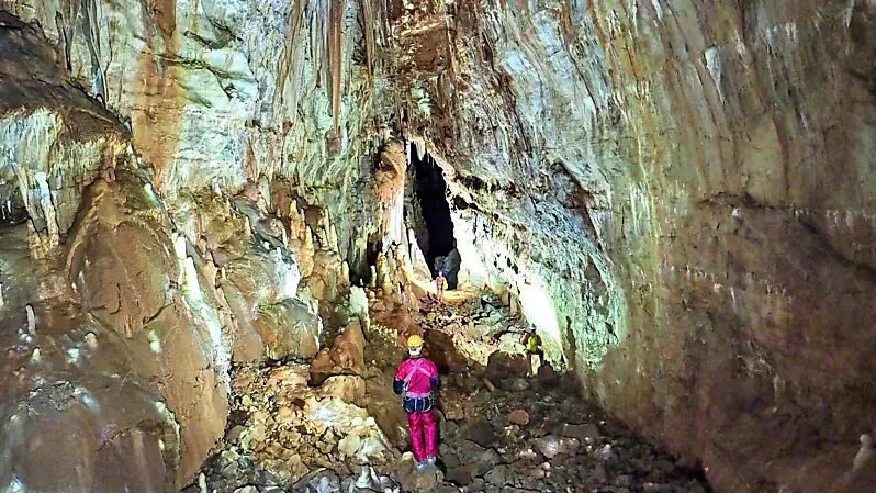 Uno speleologo contempla la vasta sala scopetra nella Matejeva Jama (foto di Daniela Perhinek)