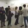 La facciata di Casa Cavazzini dedicata a Mizuki e i visitatori tra i pannelli della mostra