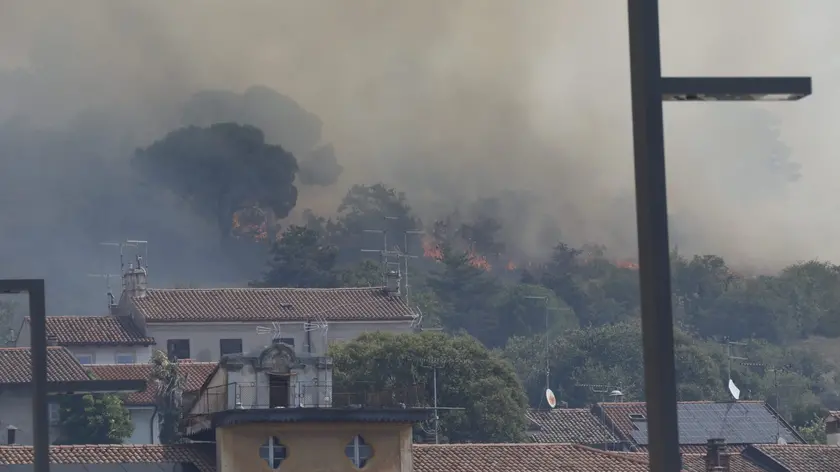 Le fiamme e il fumo dai piedi della Rocca, simbolo di Monfalcone