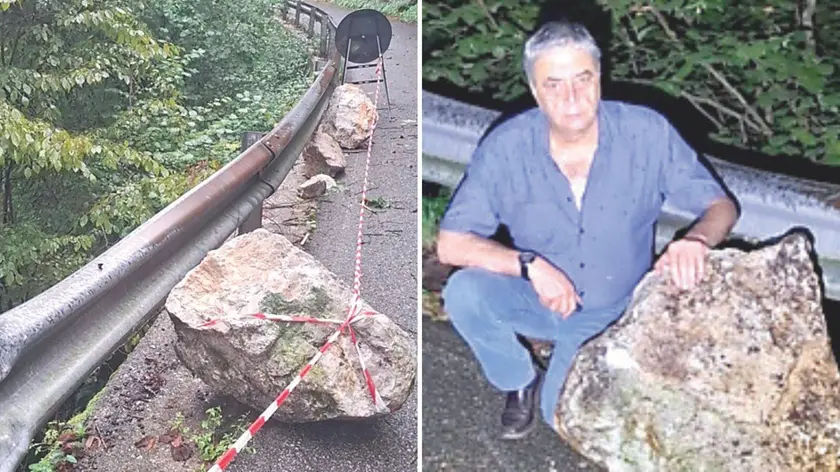 Rocce contro il guardrail, a destra il sindaco di Lusevera con uno dei massi franati sulla strada