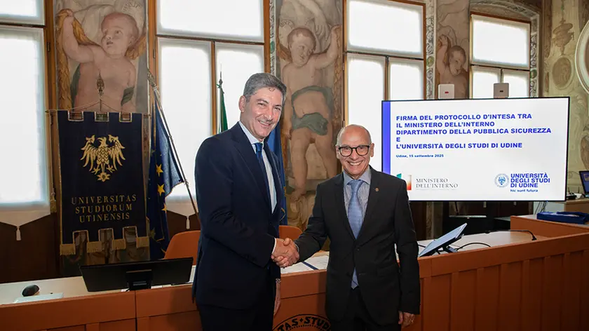 La stretta di mano tra il capo della polizia Vittorio Pisani (a sinistra), e il rettore dell'Università di Udine Roberto Pinton