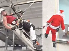 Tommaso Andreuzza al lavoro e mentre si cala con le funi vestito da Babbo Natale