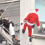 Tommaso Andreuzza al lavoro e mentre si cala con le funi vestito da Babbo Natale