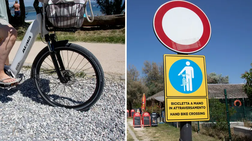 A sinistra la bici “affondata” nella ghiaia, a destra il cartello di “bici a mano” (fotoservizio Katia Bonaventura)