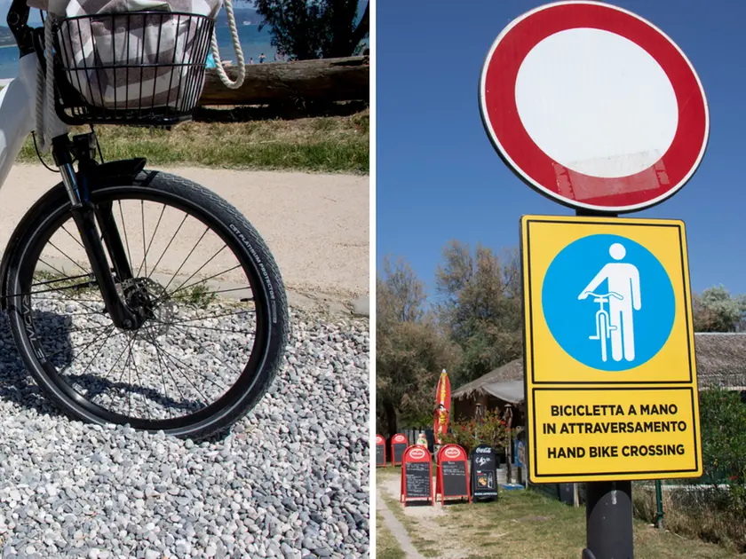 A sinistra la bici “affondata” nella ghiaia, a destra il cartello di “bici a mano” (fotoservizio Katia Bonaventura)
