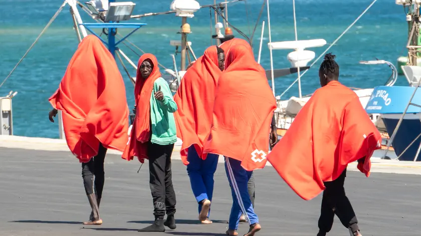 epa11623987 Migrants react upon their arrival at Arrecife's port, in Lanzarote, Canary Islands, Spain, 25 September 2024. Some 43 migrants were rescued by 'Cima de Oro' vessel as they were trying to reach the island on a small dugout. EPA/ADRIEL PERDOMO