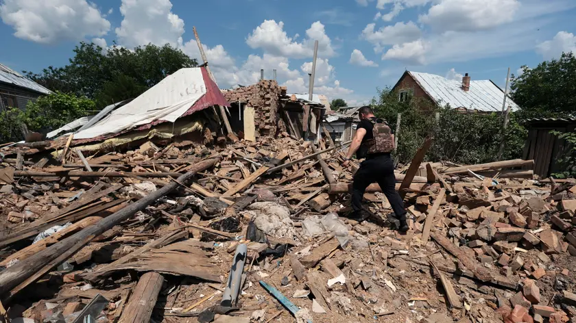 epa11402797 A police officer inspects the rubble of a private building hit by shelling, in Orikhiv, near the frontline in the Zaporizhzhia region, southeastern Ukraine, 10 June 2024, amid the Russian invasion. Less than a thousand people, mostly elderly, still live in Orikhiv as opposed to the 15,000 inhabitants before the Russian invasion. There is currently no water or gas, electricity is scarcely available and locals spend most of their day seeking shelter in basements to protect themselves from daily shelling. Russian troops entered Ukraine on 24 February 2022 starting a conflict that has provoked destruction and a humanitarian crisis. EPA/KATERYNA KLOCHKO