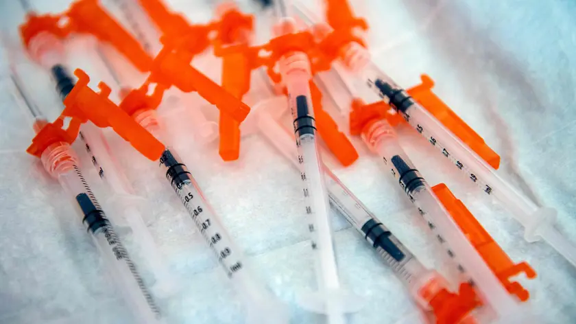 (FILES) In this file photo taken on June 21, 2022 syringes containing the Moderna Covid-19 vaccination for 6 month olds to 5 year olds lay on a table waiting to be used at Temple Beth Shalom in Needham, Massachusetts, on June 21, 2022. The temple was one of the first sites in the state to offer vaccinations to anyone in the public. - Moderna on June 22, 2022 said its new Covid booster candidate, which it is hoping to get approved this fall, performed well against Omicron's latest subvariants. (Photo by Joseph Prezioso / AFP)