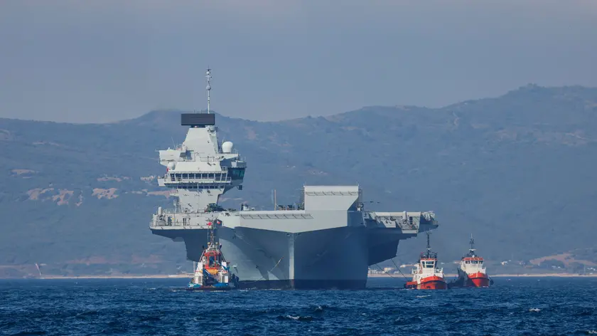 epa09328199 A handout picture provided by the UK Ministry of Defence shows the HMS Prince of Wales arriving in Gibraltar, 06 July 2021 (issued 07 July 2021). The Royal Navy aircraft carrier has made its first overseas port visit in Gibraltar. EPA/Mark Johnson/BRITISH MINISTRY OF DEFENCE/HANDOUT MANDATORY CREDIT: MOD/CROWN COPYRIGHT HANDOUT EDITORIAL USE ONLY/NO SALES
